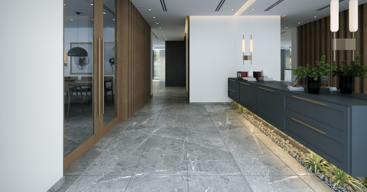 Upscale commercial office lobby with gray tile floors, dark grout lines, glass conference room doors, and mirrors